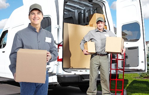 Professional movers carrying items in Shoreditch apartment building
