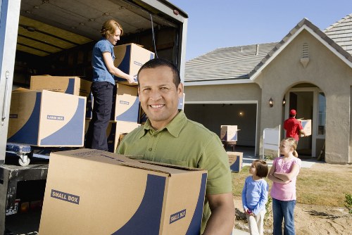 Packed household items prepared for transport by removals crew